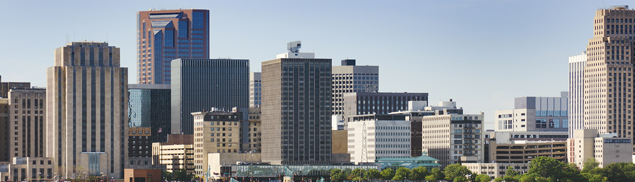 St. Paul, Minnesota, U.S.A. downtown district scenic urban skyline viewed from across a bridge over the Mississippi River on a clear summer day. Horizontal view with copy space. 